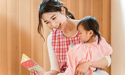 先生と子どもが絵本を読んでいる